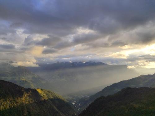 a view of a misty valley in the mountains at Cafekush tosh in Tosh