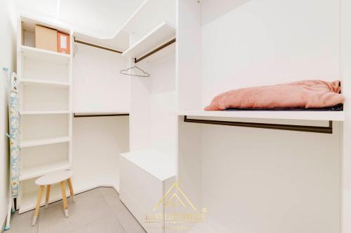 a bedroom with white walls and a bed on a shelf at Avorio Wonderful and Modern Loft in Bellinzona -By EasyLife Swiss in Bellinzona