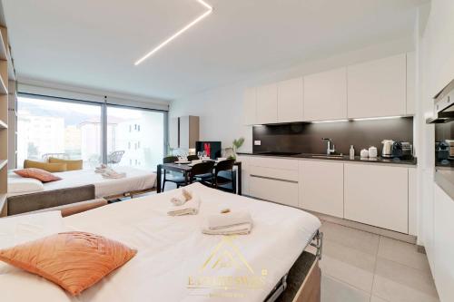 - une cuisine avec 2 lits et une table dans une chambre dans l'établissement Avorio Wonderful and Modern Loft in Bellinzona -By EasyLife Swiss, à Bellinzone