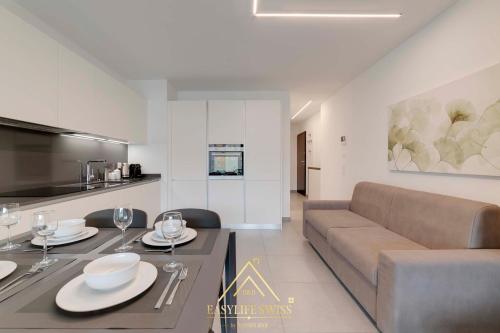 a living room with a couch and a table with wine glasses at Avorio Wonderful and Modern Loft in Bellinzona -By EasyLife Swiss in Bellinzona
