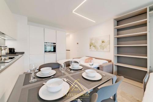 a kitchen and dining room with a table and chairs at Avorio Wonderful and Modern Loft in Bellinzona -By EasyLife Swiss in Bellinzona
