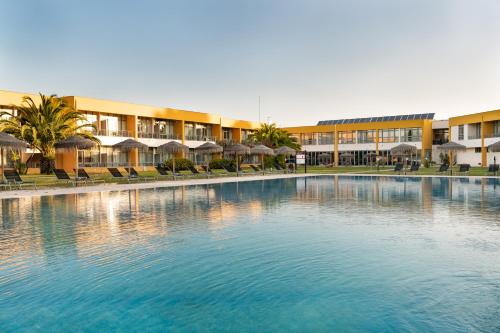 a large swimming pool in front of a building at VILA PARK Nature & Business Hotel in Santo André