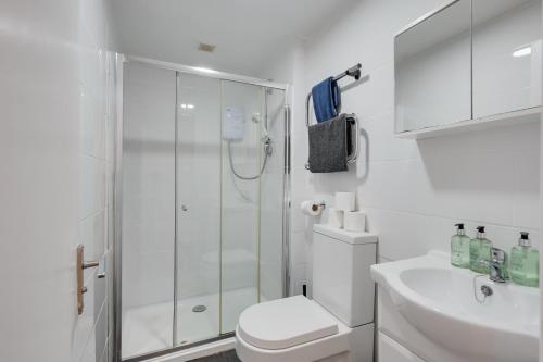 La salle de bains est pourvue d'une douche, de toilettes et d'un lavabo. dans l'établissement 4 Person Modern Apartment Nr City Centre, à Cardiff