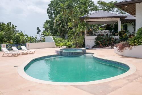 a swimming pool in the middle of a patio at Windance Villa in Mount Irvine