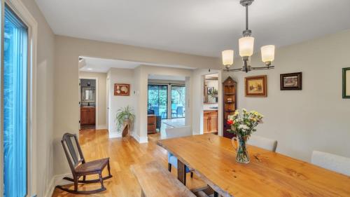 a dining room with a table and a vase of flowers at Eugene - Close to everything home in Eugene