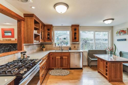 a kitchen with wooden cabinets and a stove top oven at Eugene - Close to everything home in Eugene