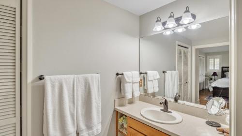 a white bathroom with a sink and a mirror at Eugene - Close to everything home in Eugene