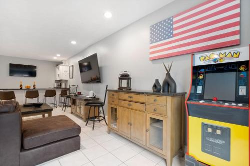 a living room with an american flag on the wall at Heart of Southie - Hot Tub + Walk to Top Bars in Boston