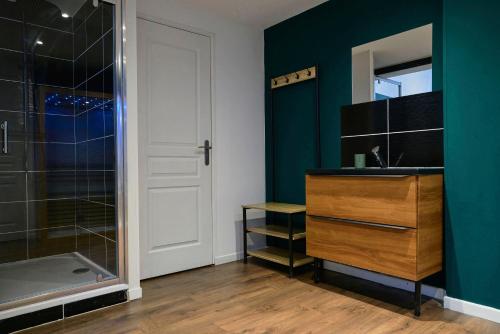 a bathroom with a shower and a sink and a mirror at NG Prestige - Nain I Suite Spa Privatif Premium I Jacuzzi - Sauna - Netflix - Projecteur in Roubaix