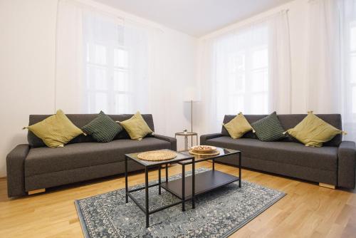 a living room with a couch and a table at Stephansdom Premium Apartments in Vienna