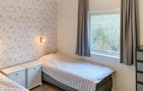 a small bedroom with a bed and a window at Amazing Home In Trans With 6 Bedrooms, Sauna And Wifi in Tranås