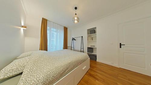a white bedroom with a bed and a closet at The Square, Paris-Asnières, Private Apartment with Bedroom and Living Room in Asnières-sur-Seine