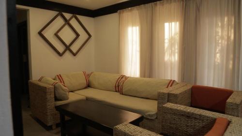 a living room with a couch and a table at CommonLens Inn in Entebbe