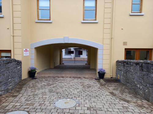 an entrance to a building with a brick walkway at Town Square Holiday Homes in Lisdoonvarna