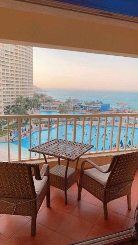 a balcony with a table and chairs and a view of the ocean at بورتو السخنه in Ain Sokhna