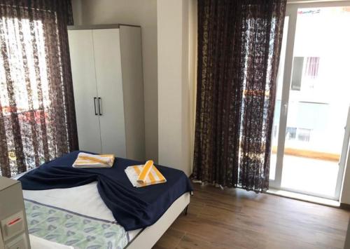 a bedroom with a bed and a large window at BONE BEST OTEL in Antalya