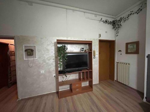 a living room with a flat screen tv on a wall at Mirella Apt, 2Min Train Station in Mestre