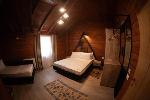 a small bedroom with a bed and a window at Hotel Avdi Rexha in Kolgecaj