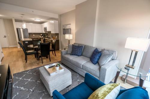 a living room with a couch and a table at Modern Apart Downtown with Indoor Pool in Stamford