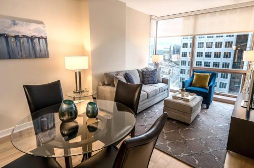 a living room with a glass table and chairs at Modern Apart Downtown with Indoor Pool in Stamford