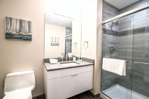 a bathroom with a toilet and a sink and a shower at Modern Apart Downtown with Indoor Pool in Stamford