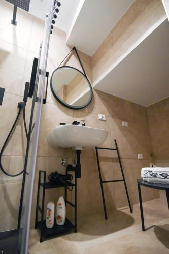 a bathroom with a sink and a mirror on the wall at Suitehome B&B con vasca in Troia