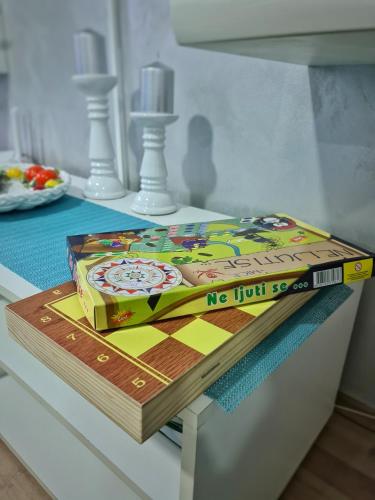 two books sitting on top of a table at Grand Blue 2 Bedroom Apartment Sokobanja in Soko Banja
