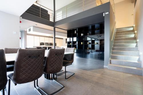 a dining room with a table and chairs at Villa Aquatenne in Tenneville