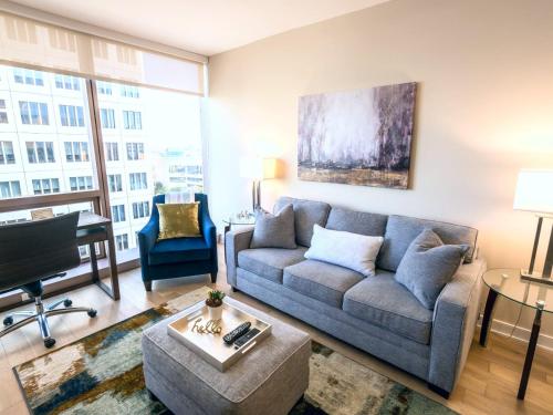 a living room with a couch and a piano at Spacious Apt Downtown with Gym in Stamford