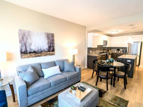 a living room and kitchen with a couch and a table at Spacious Apt Downtown with Gym in Stamford