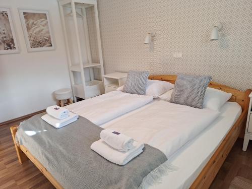 two beds in a room with towels on them at Apartments Mertelj in Kranjska Gora