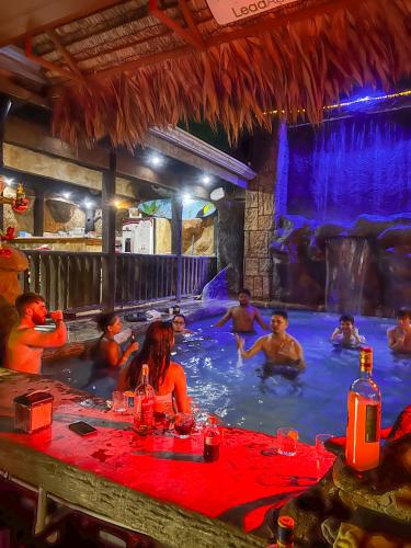 a group of people in a swimming pool at Poshtel Arenal in Fortuna