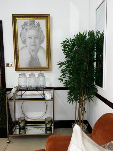 a living room with a picture of a man on the wall at Park Lane Apartments/Shaw House in London