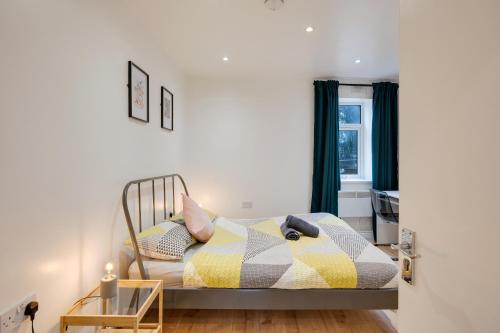 カーディフにあるRelax in a modern Cardiff home by the City Centre & Bute Parkのベッドルーム1室(カラフルな毛布付きのベッド1台付)