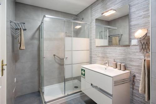 a bathroom with a shower and a sink at Ericeira Beach Apartment in Ericeira