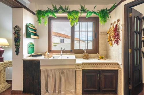 uma cozinha com um lavatório e uma janela em Villa Aurora with Heated Pool em La Cisnera