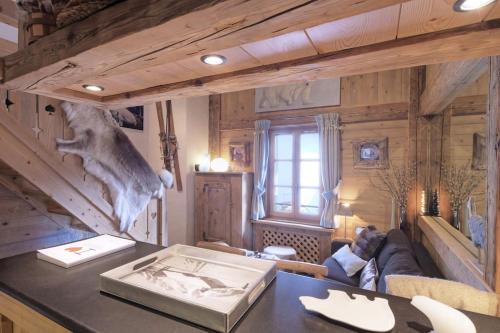 a living room with wooden walls and a table at Duplex Chaleureux au Cœur de Megève 2 p in Megève