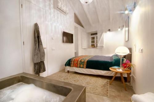 a bathroom with a bed and a tub in a room at Stylish town house in Silves in Silves