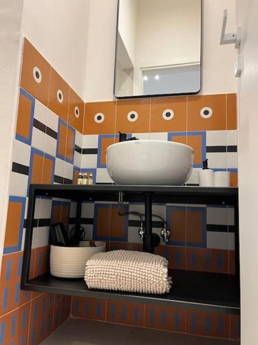 a bathroom with a sink and a mirror at Uliveus - Villa Duna fronte mare in Faccia di Trippa