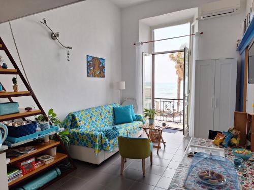 a living room with a couch and a view of the ocean at Mowita in Civitavecchia