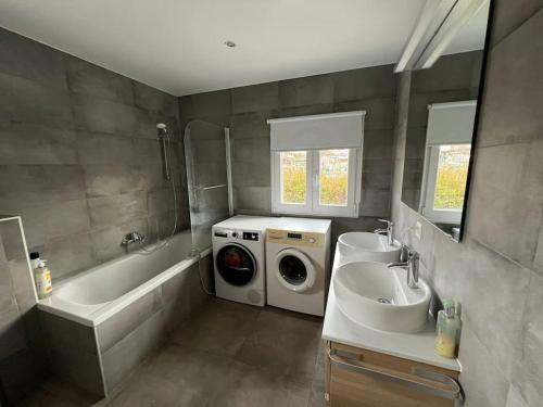 a bathroom with a washing machine and a sink at House Near EPFL/Unil/Renens Gare/Lausanne in Ecublens