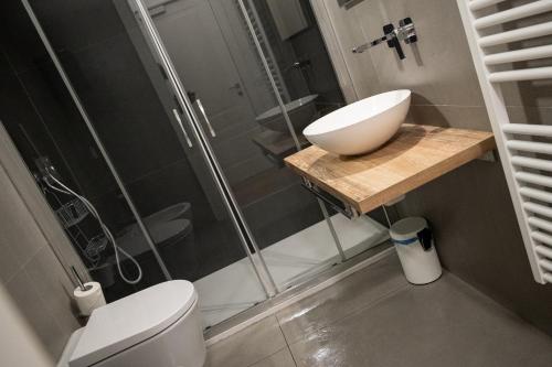 a bathroom with a toilet and a sink and a shower at City Gallery Apartments in Trieste
