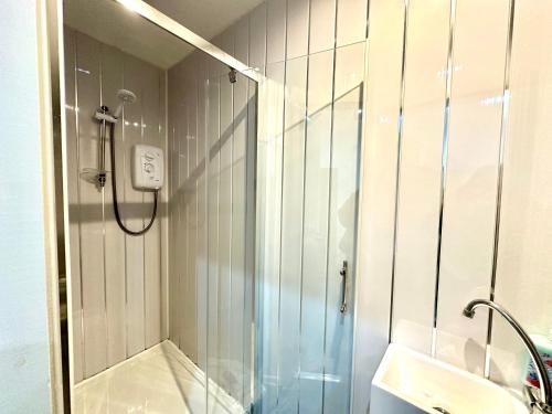 a bathroom with a shower and a sink at York Street Apartments by Blackpool Service Apartments in Blackpool