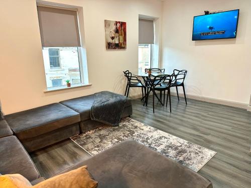 a living room with a couch and a table at York Street Apartments by Blackpool Service Apartments in Blackpool