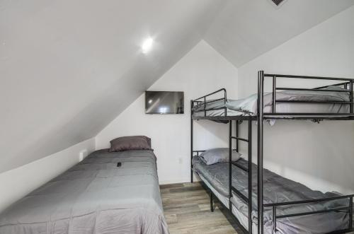 a bedroom with two bunk beds in a attic at Spacious Lexington Home with Fire Pit Hunt and Fish! 