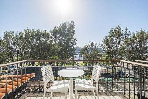 a patio with a table and chairs on a balcony at King David Suites by Homie in Funchal