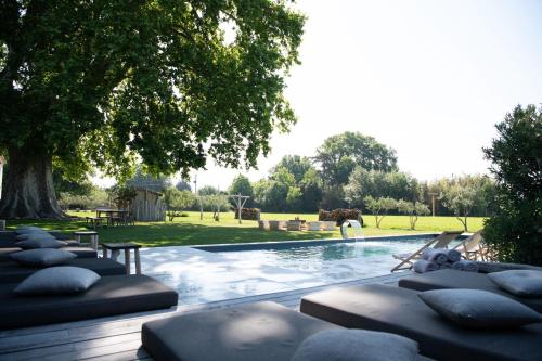 - une piscine avec des oreillers dans un parc dans l'établissement Mas d images styled by Scapa Home, à Arles
