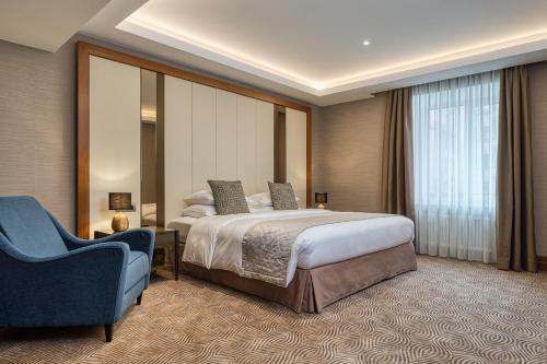 A bed or beds in a room at Grand Hotel Kempinski Riga