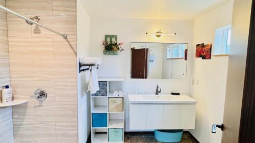 a white bathroom with a sink and a shower at Lake Marie Lodge #22 in Rockaway Beach