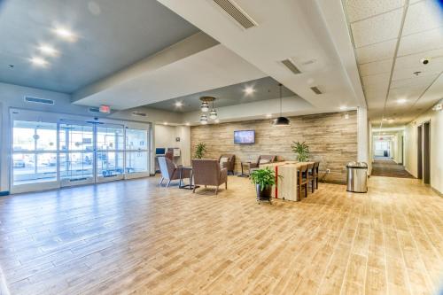 an empty office with a lobby with a desk and chairs at Candlewood Suites New Bern by IHG in New Bern